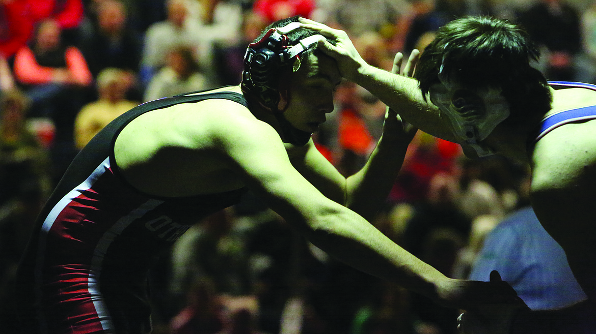 Connor Vanderweyst/Columbia Basin Herald
Othello's TJ Martinez (left) tries to shake off an attack by Ellensburg's Andrew Carney in the 195-pound championship. Martinez won in overtime 4-2.