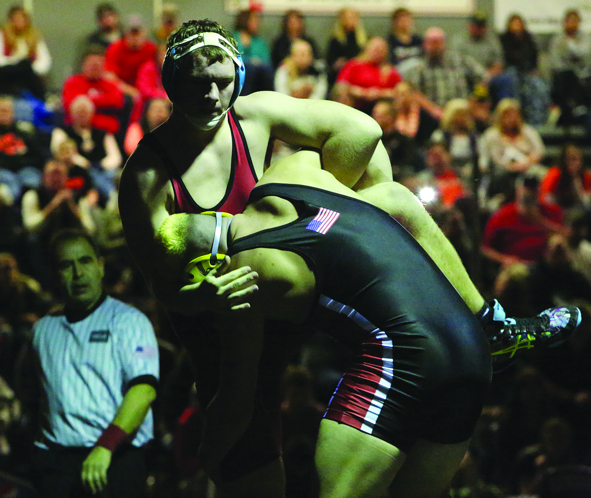 Connor Vanderweyst/Columbia Basin Herald
Othello's Isaiah Perez grabs onto the leg of Cheney's Josh Baker during the 220-pound regional championship. Perez won by fall.