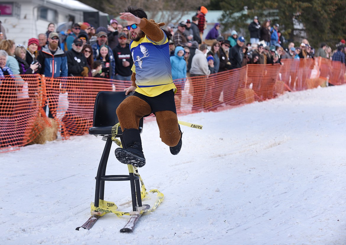 BRIAN STRODTBECK jumps onto his barstool after crashing during the Cabin Fever Days Barstool Races in Martin City on Saturday. The races continue today beginning at 1 p.m. (Aaric Bryan photos/Daily Inter Lake)