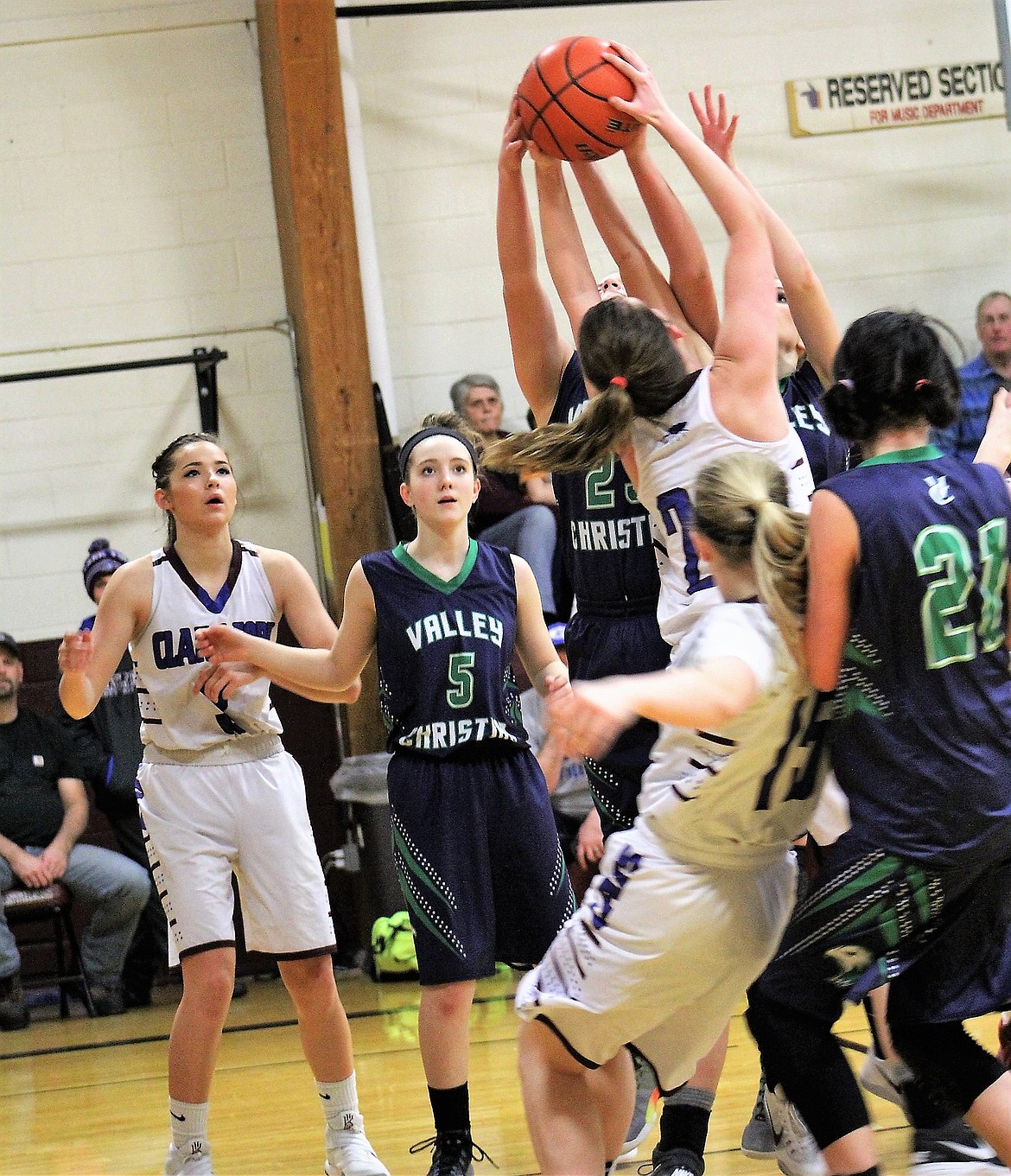 Several grab for the ball during the Clark Fork Mountain Cats game Saturday against Valley Christian. The Lady Cats walked away with the win, 61-18.  (Kathleen Woodford/Mineral Independent).