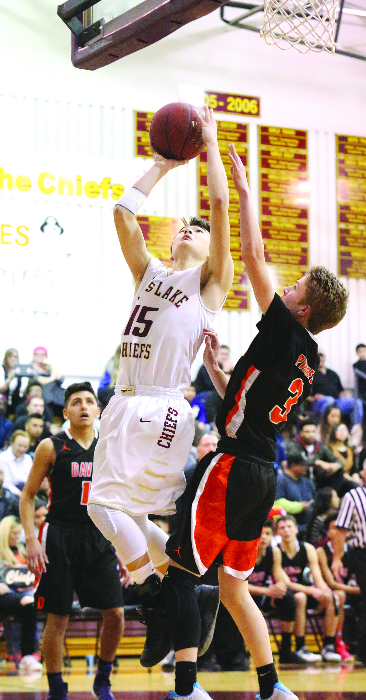 Connor Vanderweyst/Columbia Basin Herald
Moses Lake's Evan McLean (15) scores past Davis' Brock Williams.