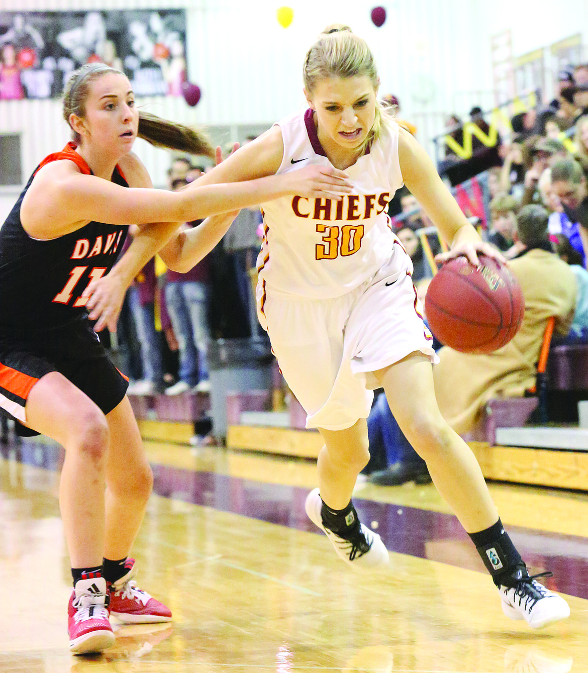 Connor Vanderweyst/Columbia Basin Herald
Moses Lake's Jessica Olson (30) dribbles past Davis' Eliza Berman Friday at Moses Lake High School.