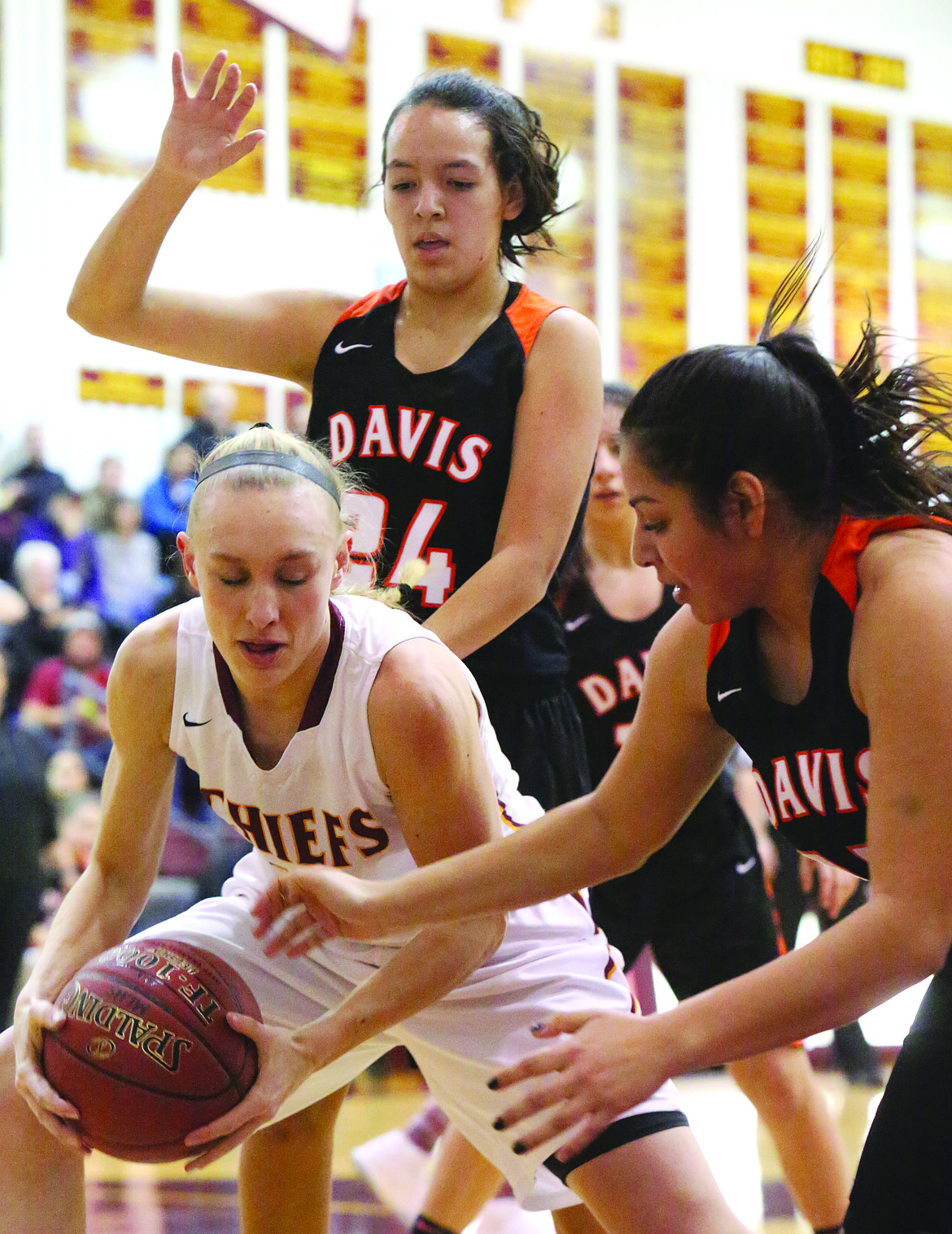 Connor Vanderweyst/Columbia Basin Herald
Moses Lake's Abby Rathbun pulls down a rebound in between two Davis defenders.