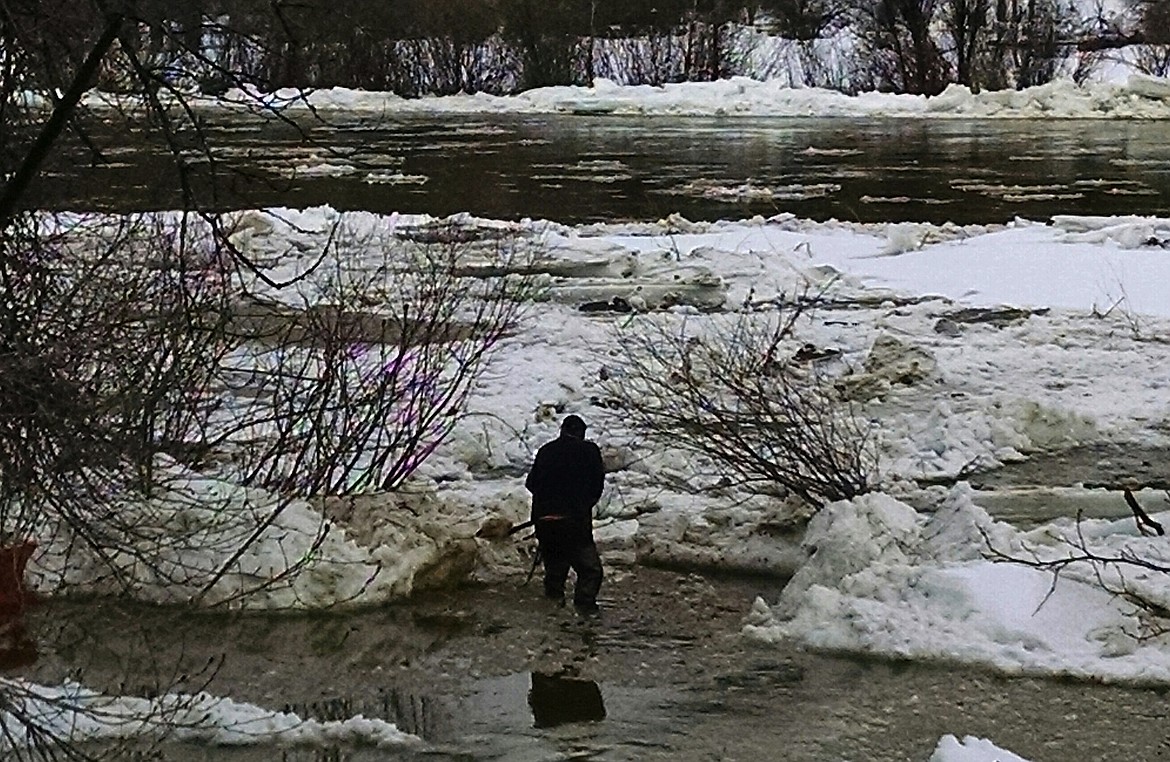 BRIAN WALKER/Press
A property owner on the St. Joe River near Calder works on Friday to redirect water from his property. Flooding on the river subsided on Monday morning when an ice dam at St. Joe City dissipated.