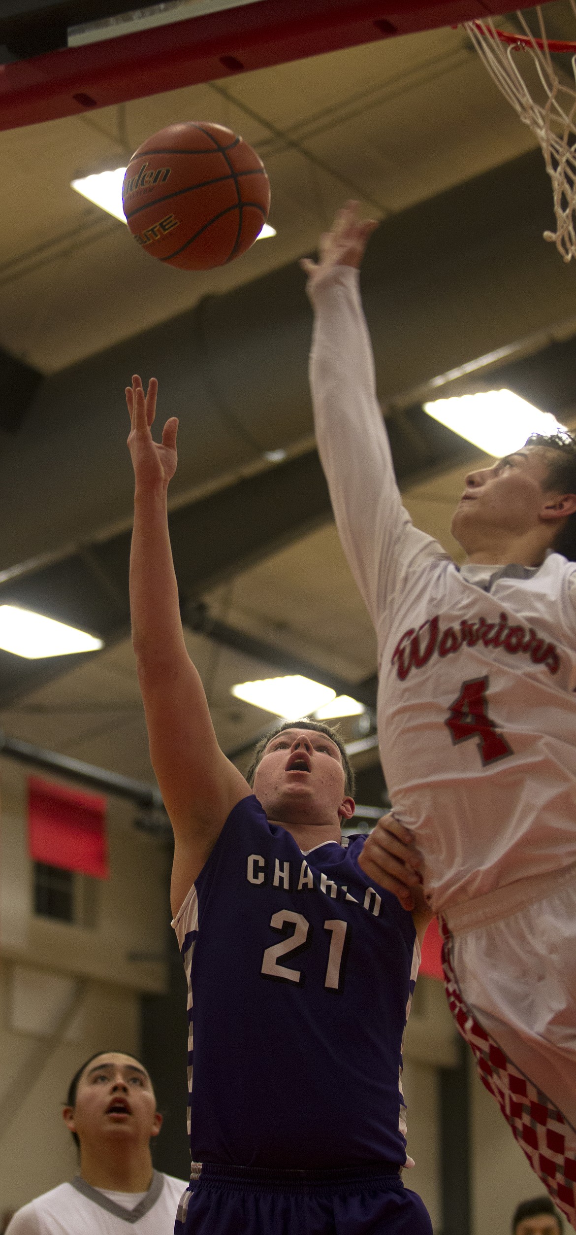 ARLEE HIGH School guard Tyler Tanner drives to the lane against Charlo High School forward Toby Odom in the regular-season finale Thursday night at Arlee High School. (Jeremy Weber/Lake County Leader)