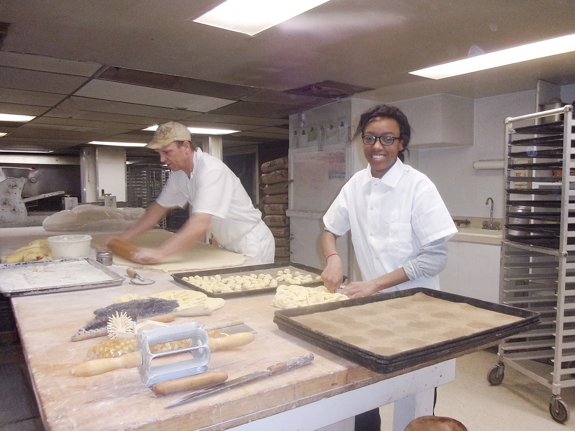 Tylesha Johnson, KHJC Culinary Arts student, receives hands-on learning from Mike Humphrey at Lake City Bakery.