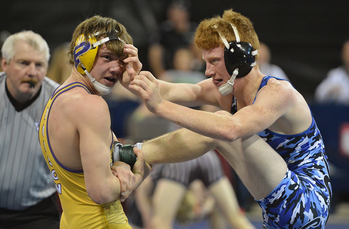 POLSON WRESTLER Cameron Brown and CODA&#146;s Drew Schmitt attempt to get good position on each other in the Montana State wrestling championship match of the 145-pound division Saturday at Rimrock Auto Arena at MetraPark in Billings. (Jason Blasco/Lake County Leader)