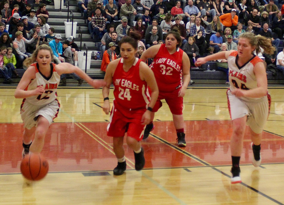 Plains Trotters Lindsay Laws (#12) and Jessica Thompson (#44) chase after the ball as Two River Lady Eagles (#24) Kristan Hewankorn and (#32) move in.