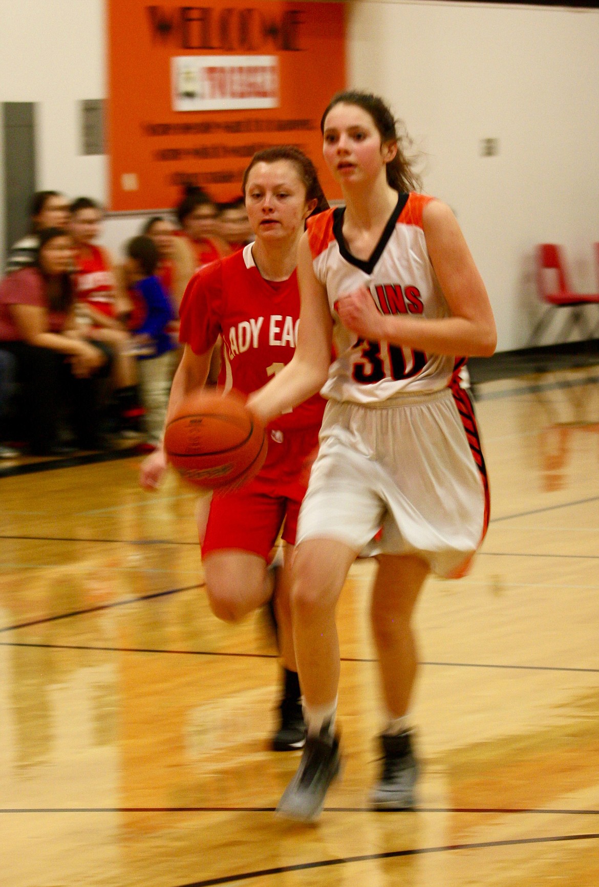 PLAINS&#146; KAYLEE Altmiller races toward the basket as a Two Eagle River defender is close behind.
