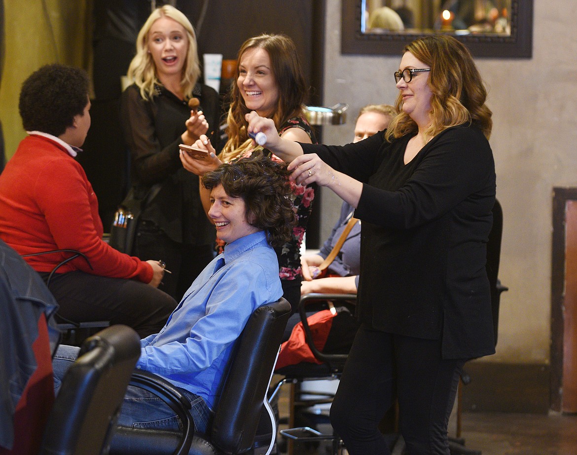 SARA MALDONADO smiles as she gets sparkles in her hair at the Soucie Soucie Salon and Medspa in Kalispell for the Night to Shine dance on Friday. (Aaric Bryan/Daily Inter Lake)