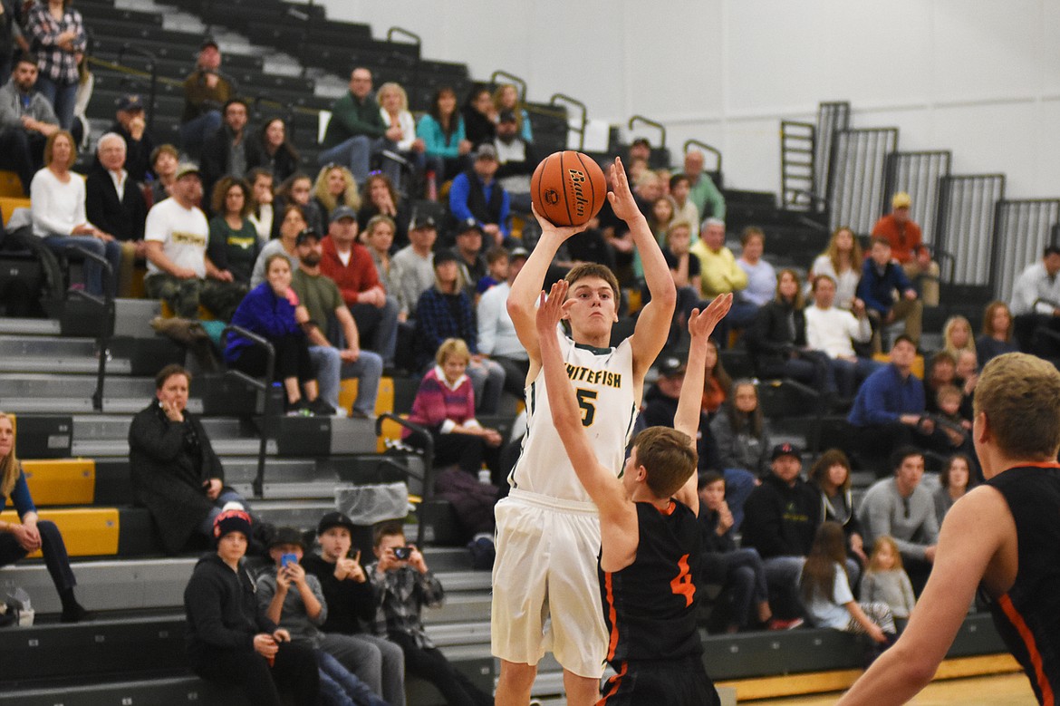 Derek Kastella launches a three at the end of regulation during Saturday&#146;s overtime win over Frenchtown. (Daniel McKay/Whitefish Pilot)