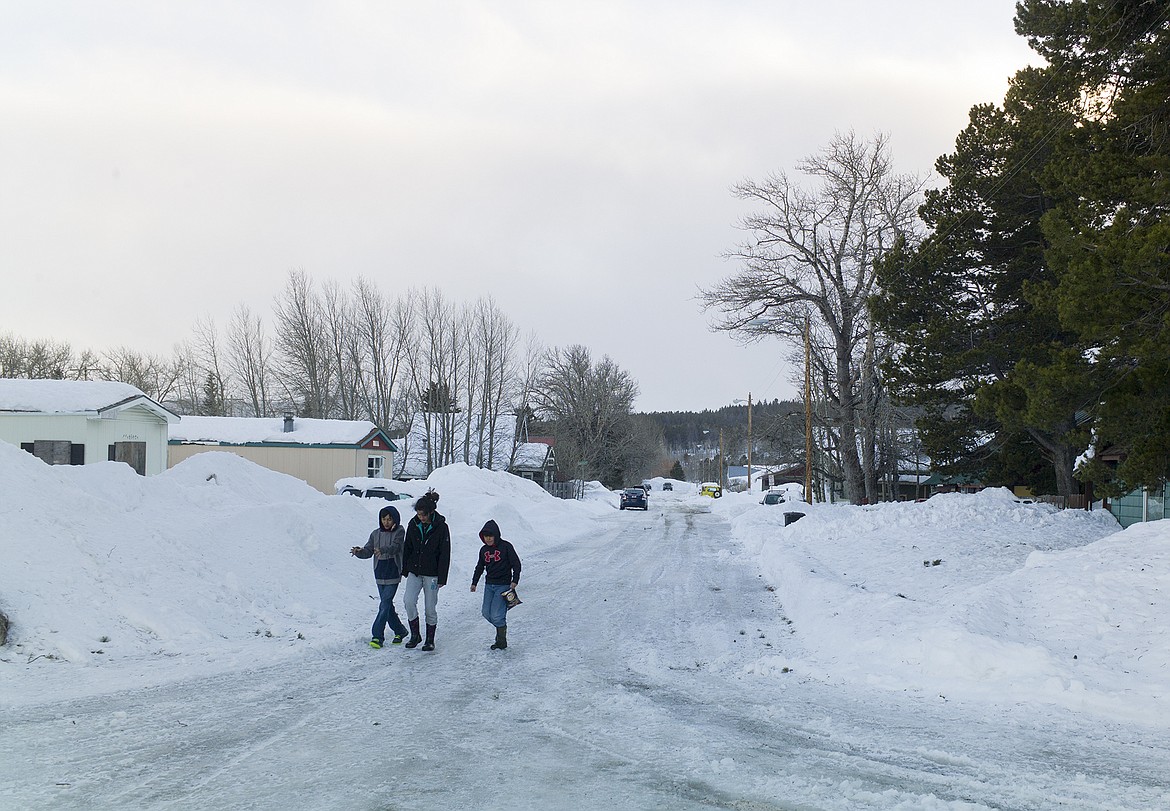 Kids walk down a street in East Glacier last week.