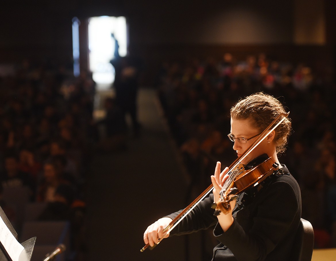 AMY HAYMOND of the Glacier Symphony performs music from the upcoming concert &#147;Star Wars, Dark Matter and Dvorak&#148; for elementary students at Flathead High School on Friday. The concerts will be open to the public at 7:30 p.m. today at the Whitefish Performing Arts Center, and at 3 p.m. Sunday at Flathead High School. (Brenda Ahearn photos/Daily Inter Lake)