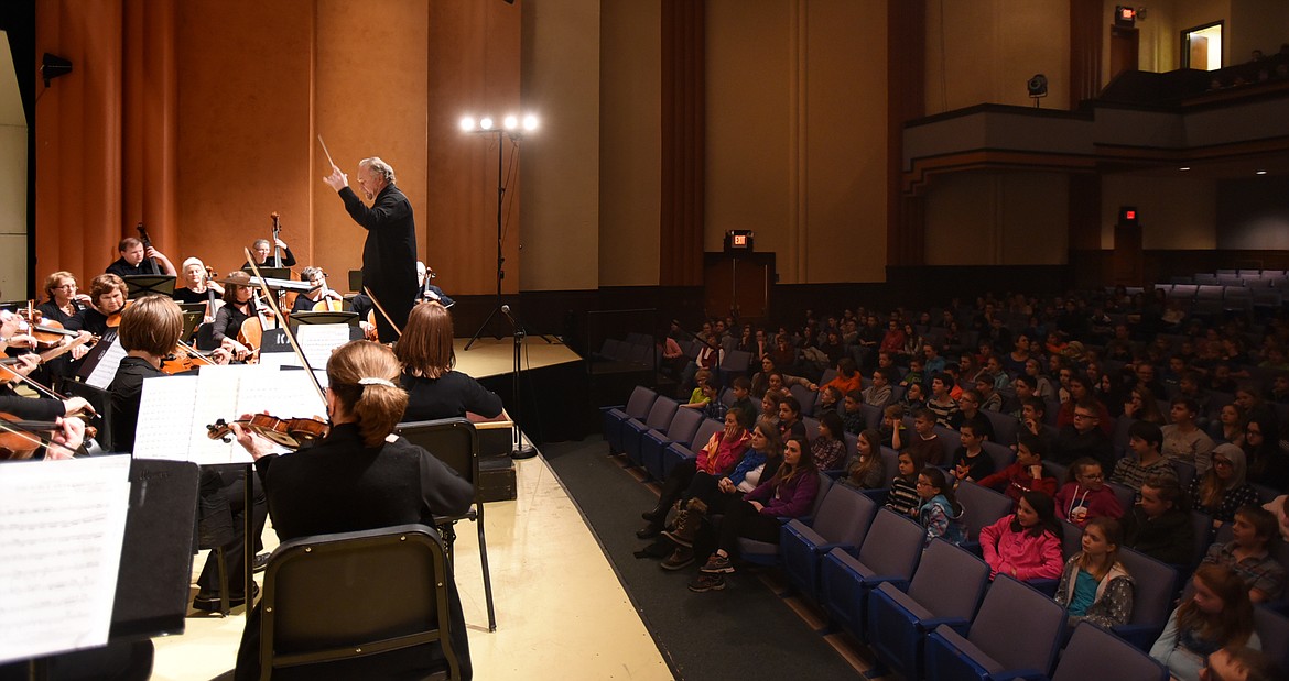 JOHN ZOLTEK leads the Glacier Symphony as they perform works from their upcoming concert for grade school children at Flathead High School on Friday morning.