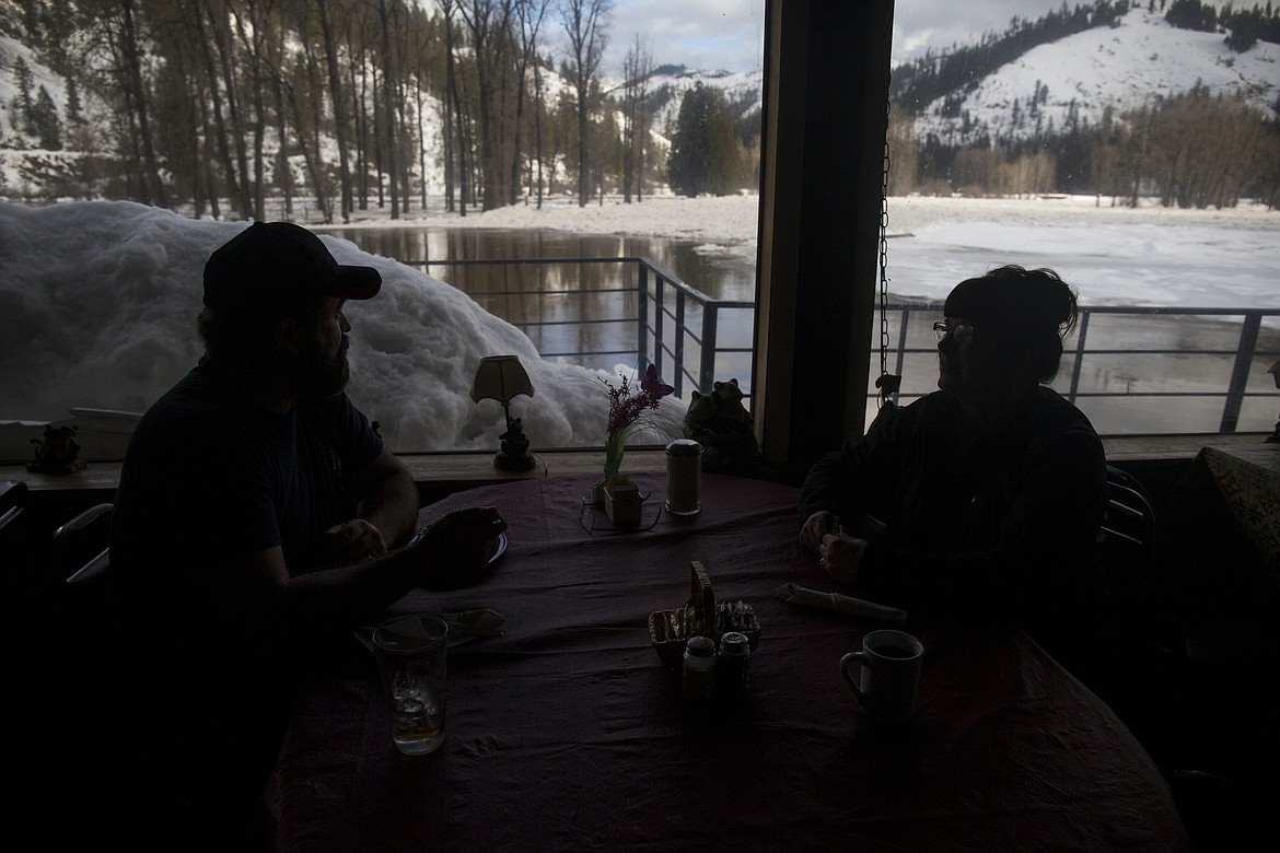 LOREN BENOIT/Press
Tony and Sherry Rothauge, of St. Maries, eat lunch inside The Big Eddy Resort as they watch the St. Joe River Friday morning.