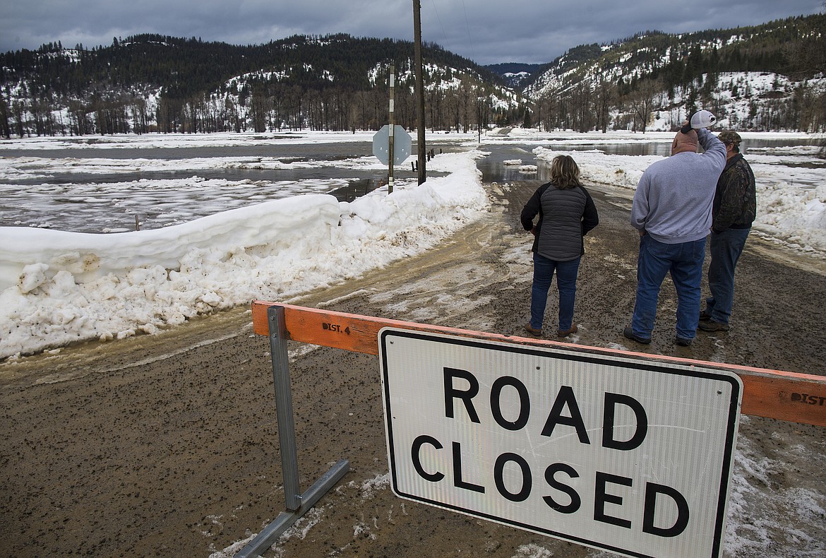 LOREN BENOIT/Press
Spectators watch as the St. Joe River floods over Elk Prairie Road in Calder Friday morning.