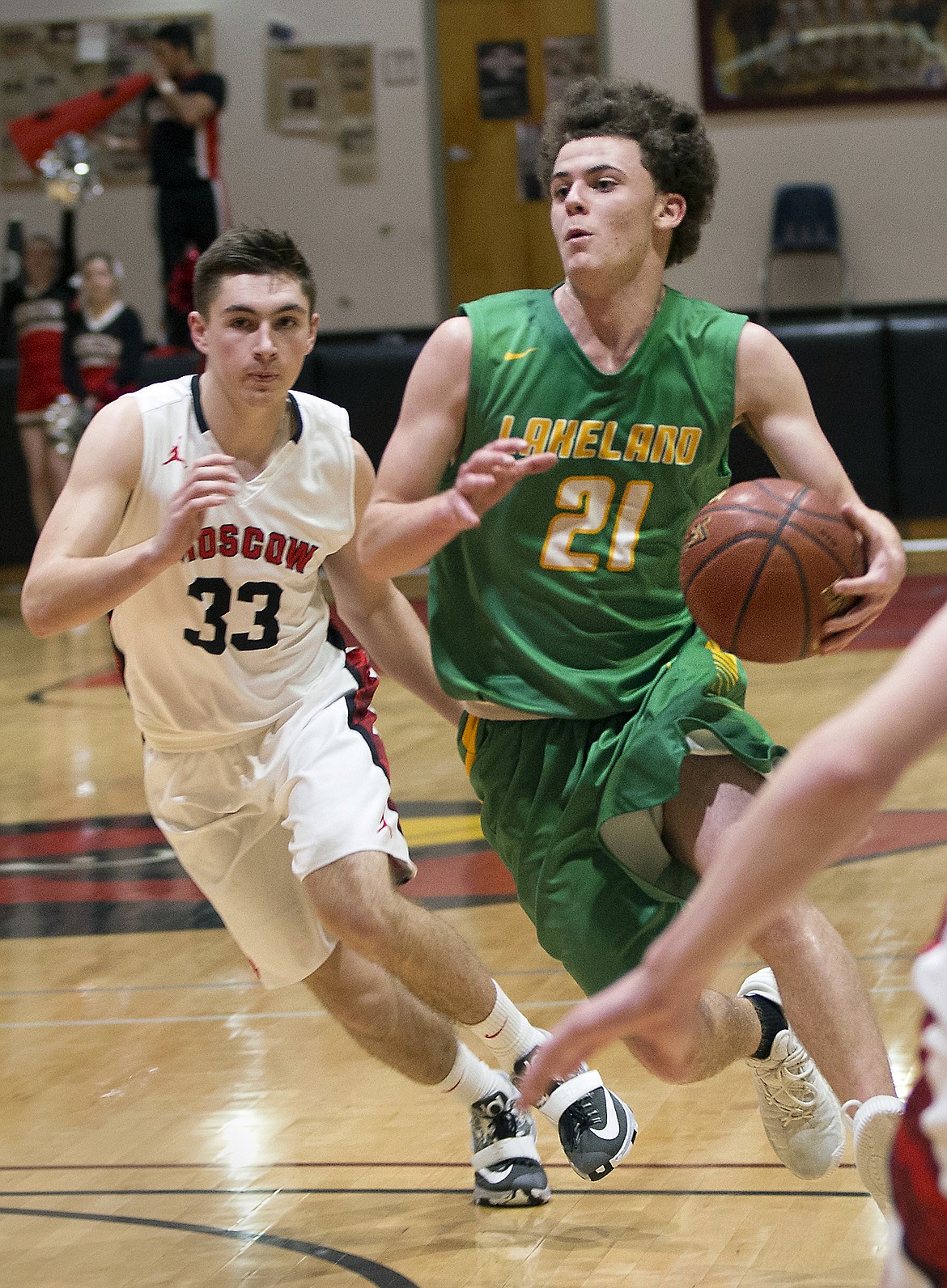 LISA JAMES/PressDylan Knight drives down the court with Jake Knott of  Moscow close at his heels during their 4A Region 1 championship game at NIC on Thursday night. Lakeland lost to Moscow, 44-45.