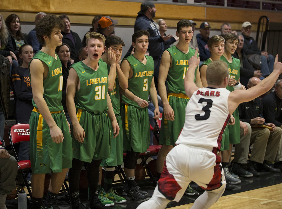 LISA JAMES/PressCooper Stephens, #3, of Moscow celebrates their win as Lakeland players react as the game ends. Lakeland lost to Moscow, 44-45, in the 4A Region 1 championship game at NIC on Thursday night.