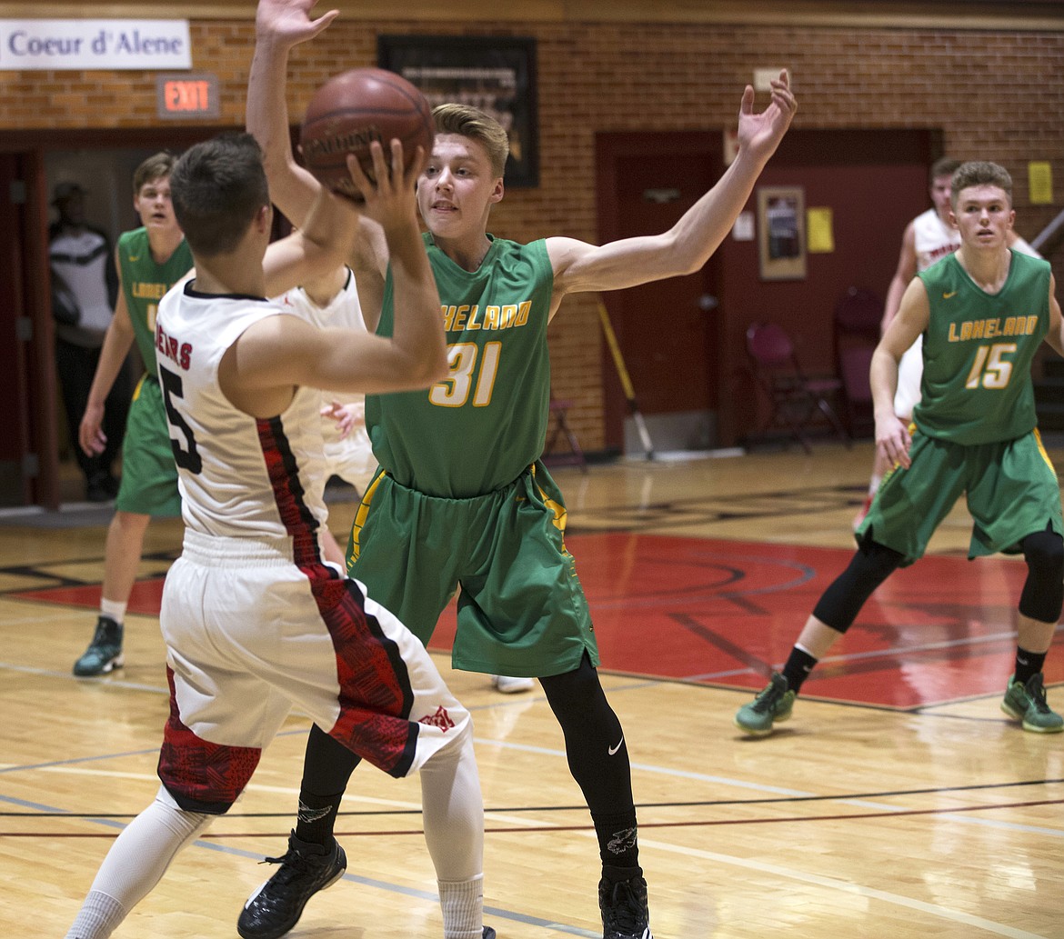 LISA JAMES/PressJosh Neilson of Lakeland tries to block Glen Gosse of Moscow from passing during their 4A Region 1 championship game at NIC on Thursday night.