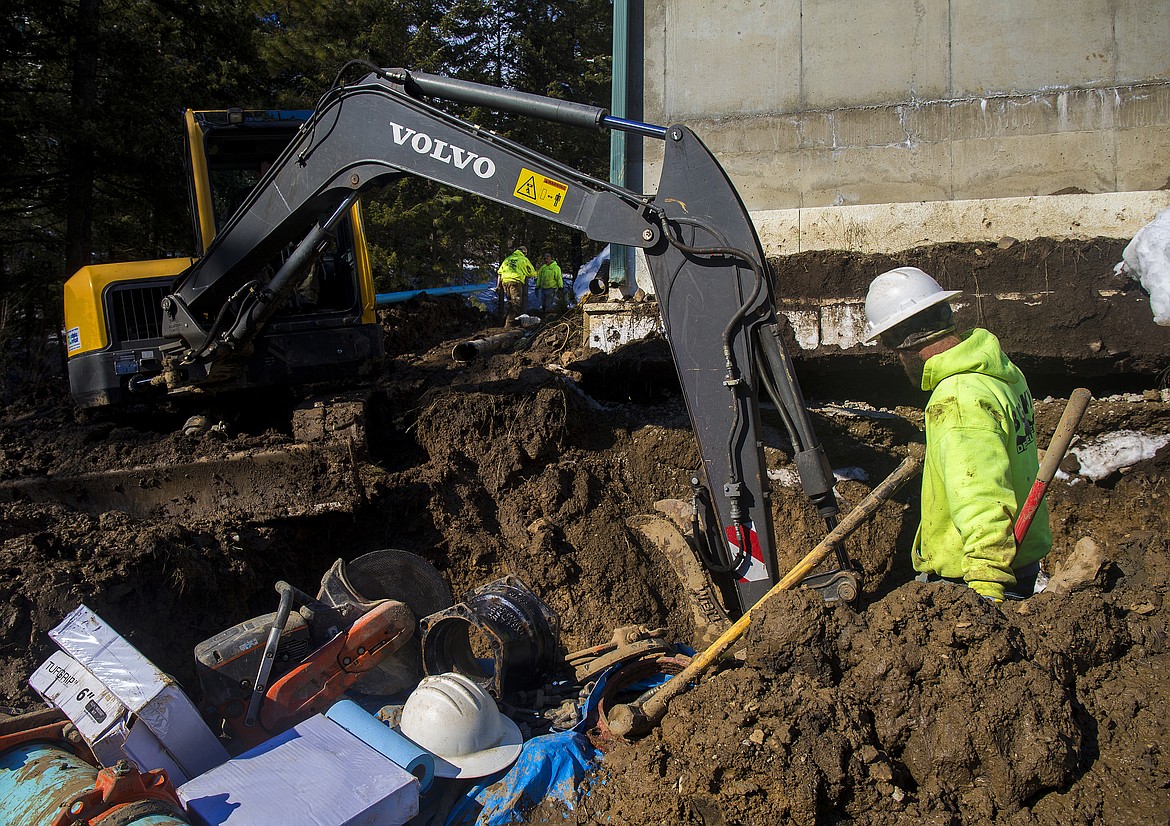 LOREN BENOIT/PressBig Sky Development employee Eric Hensyel helps fellow co-worker Lukasz Godzien repair a water system at the Kootenai County Water District No. 1 station along Sunnyside Road Thursday afternoon.