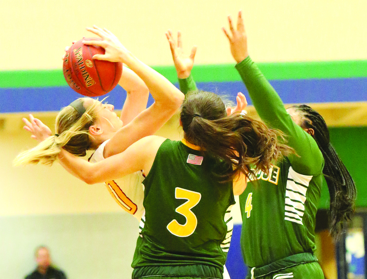 Connor Vanderweyst/Columbia Basin Herald
Moses Lake's Jessica Olson is fouled by two Kentridge defenders.