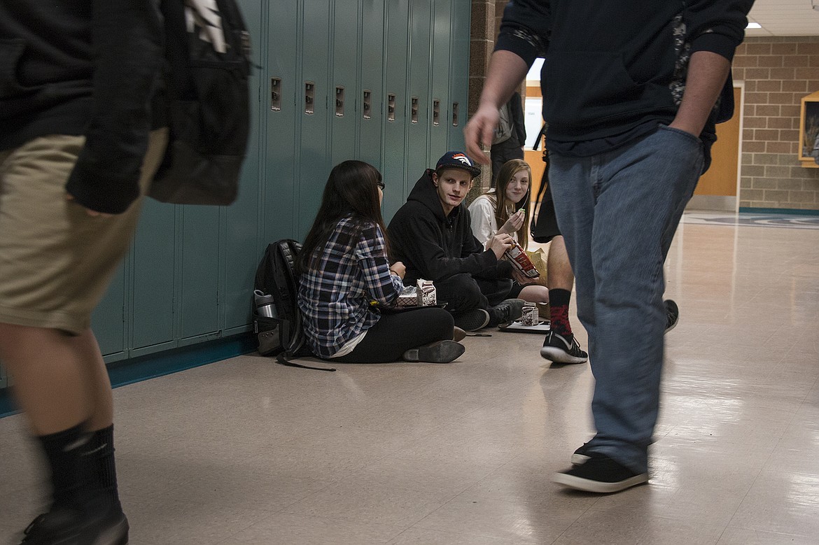 From left, Lake City High School senior Celi Barron, junior Matheu Myers and sophomore Jackie Dalleska prefer to eat in the hallways at school because the cafeteria is too crowded. The students have also struggled with other overcrowding issues such as crowded classrooms and teachers who don&#146;t have a permanent classroom. The bond the Coeur d&#146;Alene School District is putting to the voters in March would add classroom space to Lake City High School.