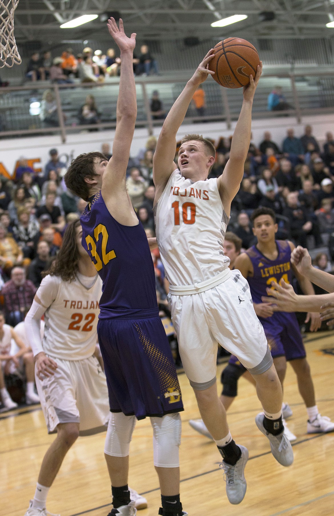 LISA JAMES/ PressTanner McCliment-Call, #10, of Post Falls shoots as Colton Richardson, right, of Lewiston approaches, and Trystan Bradley, #32, left, blocks during their State 5A Region 1 championship game at Post Falls High School on Tuesday night. Post Falls lost to Lewiston, 48-51.