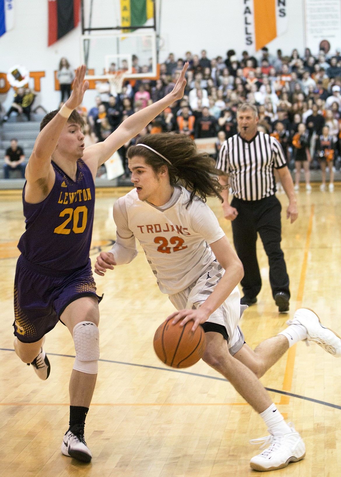 LISA JAMES/ PressJake Pfennigs of Post Falls drives down the court as Braeden Wilson of Lewiston tries to block during the second half of their State 5A Region 1 championship game at Post Falls High School on Tuesday night. Post Falls lost to Lewiston, 48-51.