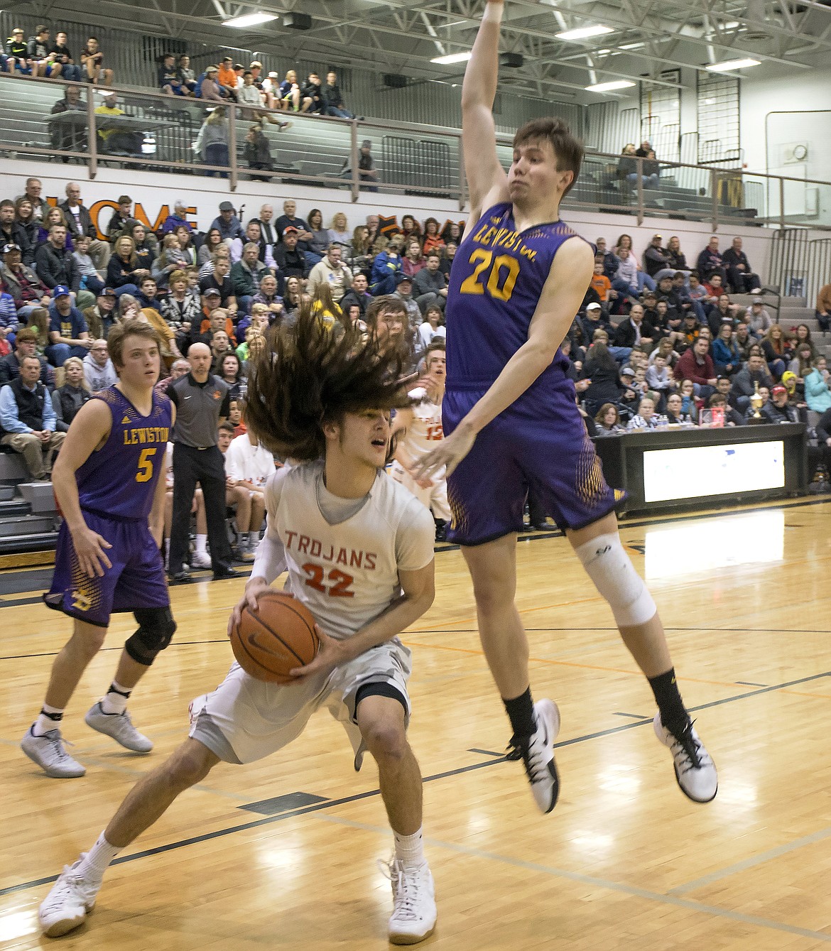 LISA JAMES/ PressBraeden Wilson of Lewiston tries to block Jake Pfennigs of Post Falls a he tries to block a layup during  their State 5A Region 1 championship game at Post Falls High School on Tuesday night. Post Falls lost to Lewiston, 48-51.