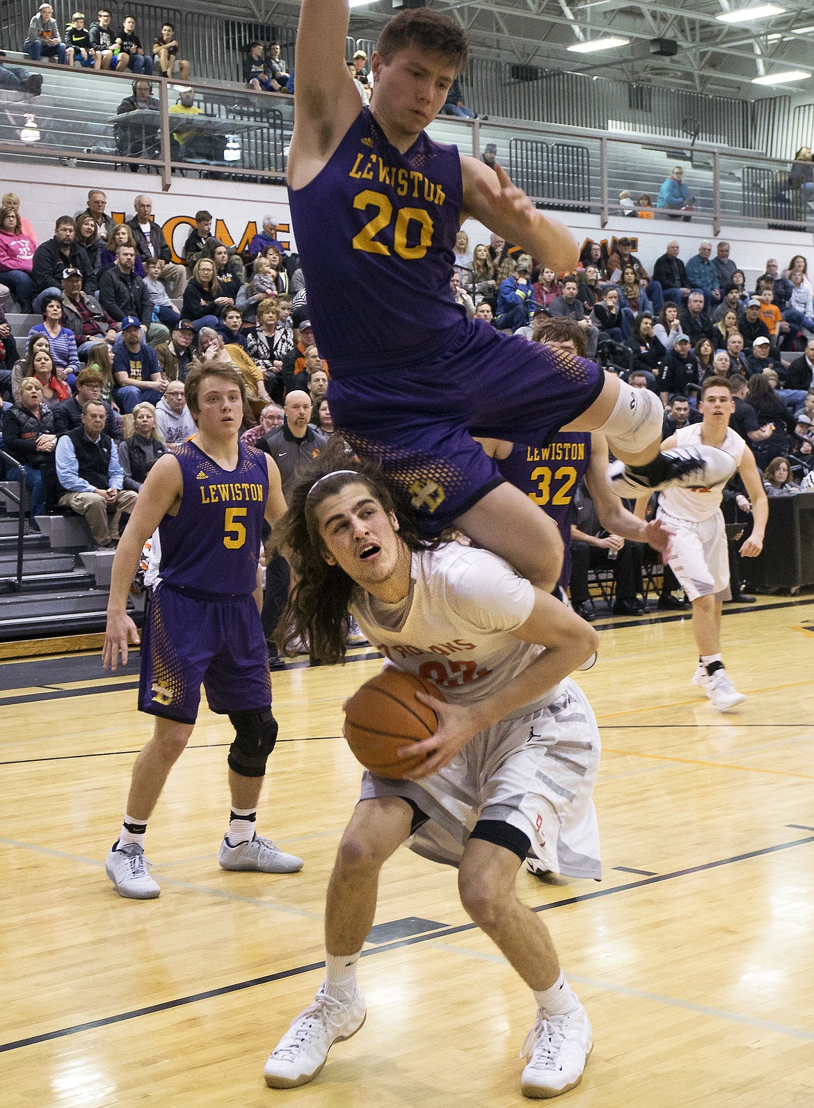 LISA JAMES/ PressBraeden Wilson of Lewiston comes down on Jake Pfennigs of Post Falls a he tries to block a layup during  their State 5A Region 1 championship game at Post Falls High School on Tuesday night. Post Falls lost to Lewiston, 48-51.