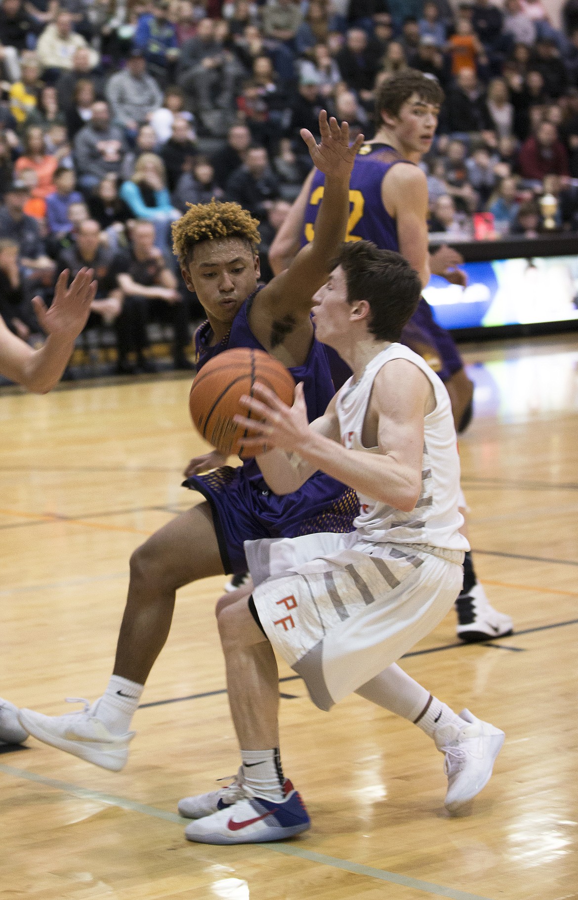 LISA JAMES/ PressDrake Thompson of Post Falls drives to the basket as Keeshawn Clark of Lewiston tries to block during their State 5A Region 1 championship game at Post Falls High School on Tuesday night. Post Falls lost to Lewiston, 48-51.