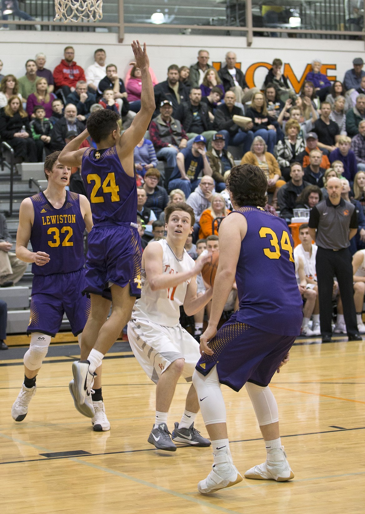 LISA JAMES/ PressCasey Walker, 11, gets ready to shoot as Colton Richardson, #34, Riley Way, #24, and Trystan Bradley, #32, of Lewiston block during their State 5A Region 1 championship game at Post Falls High School on Tuesday night. Post Falls lost to Lewiston, 48-51.