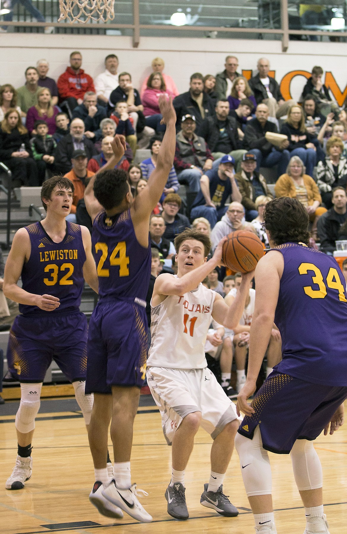 LISA JAMES/ PressCasey Walker, #11, gets ready to shoot as Colton Richardson, #34, Riley Way, #24, and Trystan Bradley, #32, of Lewiston block during their State 5A Region 1 championship game at Post Falls High School on Tuesday night. Post Falls lost to Lewiston, 48-51.