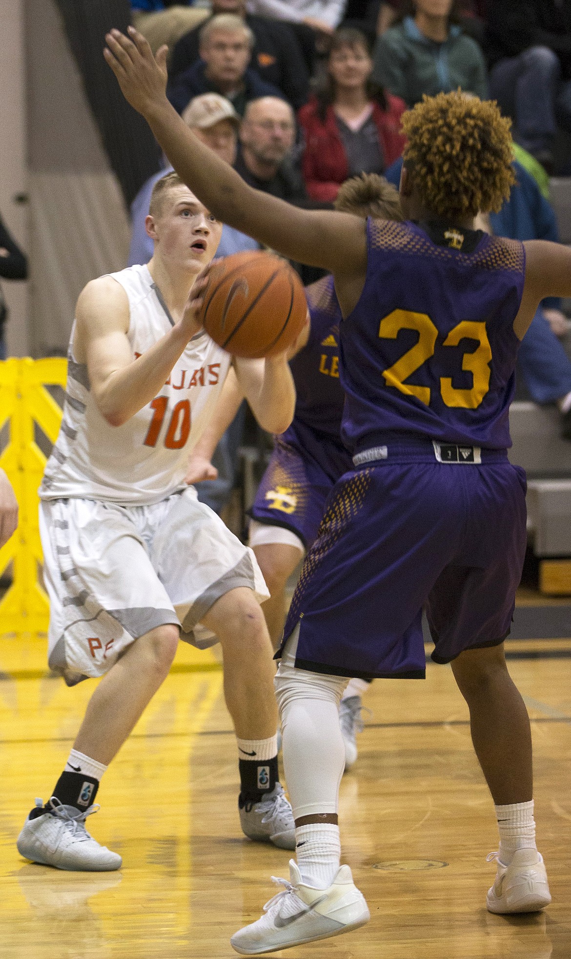 LISA JAMES/ PressTanner McCliment-Call of Post Falls looks to shoot past Keeshawn Clark of Lewiston during their State 5A Region 1 championship game at Post Falls High School on Tuesday night. Post Falls lost to Lewiston, 48-51.