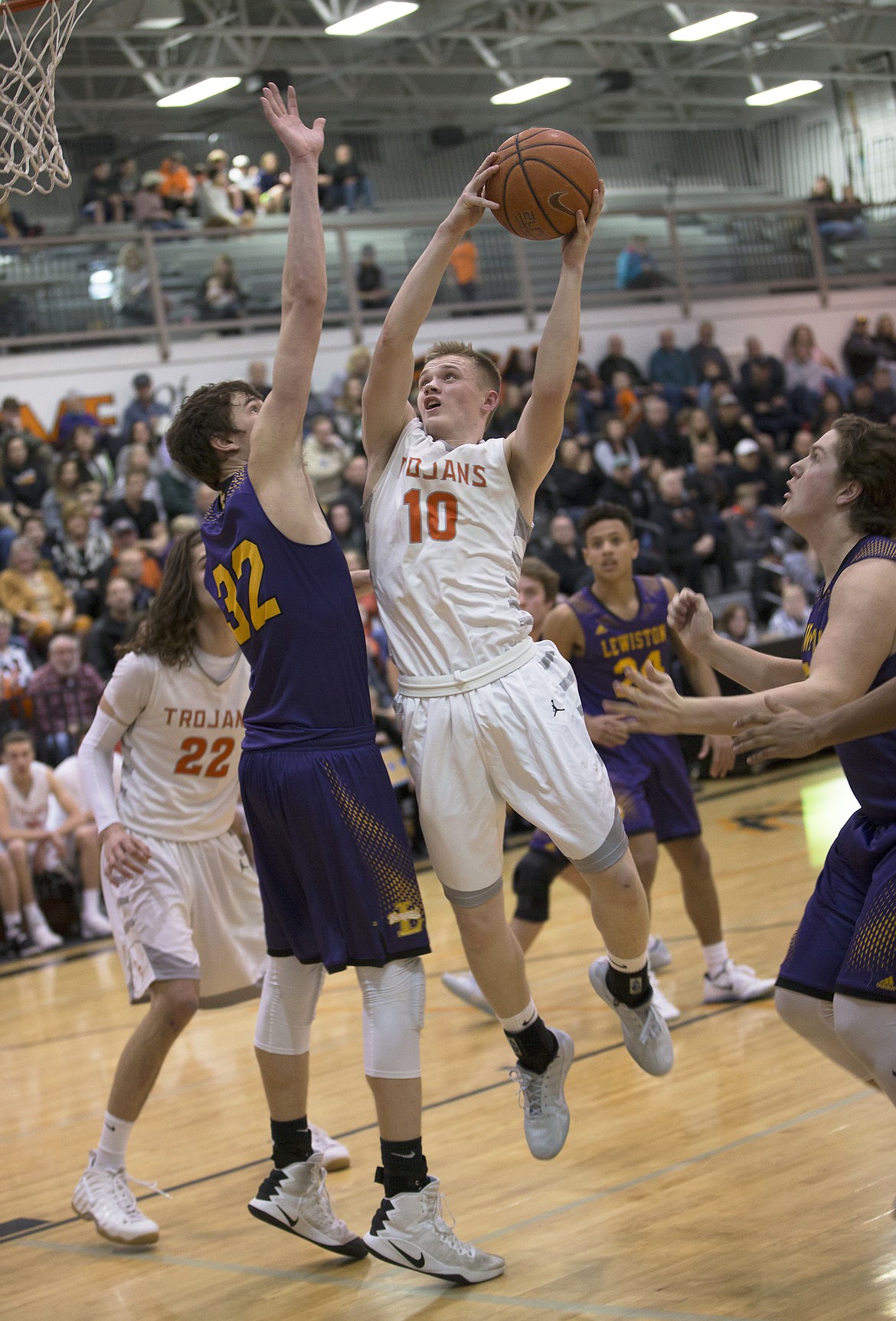 LISA JAMES/ PressTanner McCliment-Call, #10, of Post Falls shoots as Colton Richardson, right, of Lewiston approaches, and Trystan Bradley, #32, left, blocks during their State 5A Region 1 championship game at Post Falls High School on Tuesday night. Post Falls lost to Lewiston, 48-51.