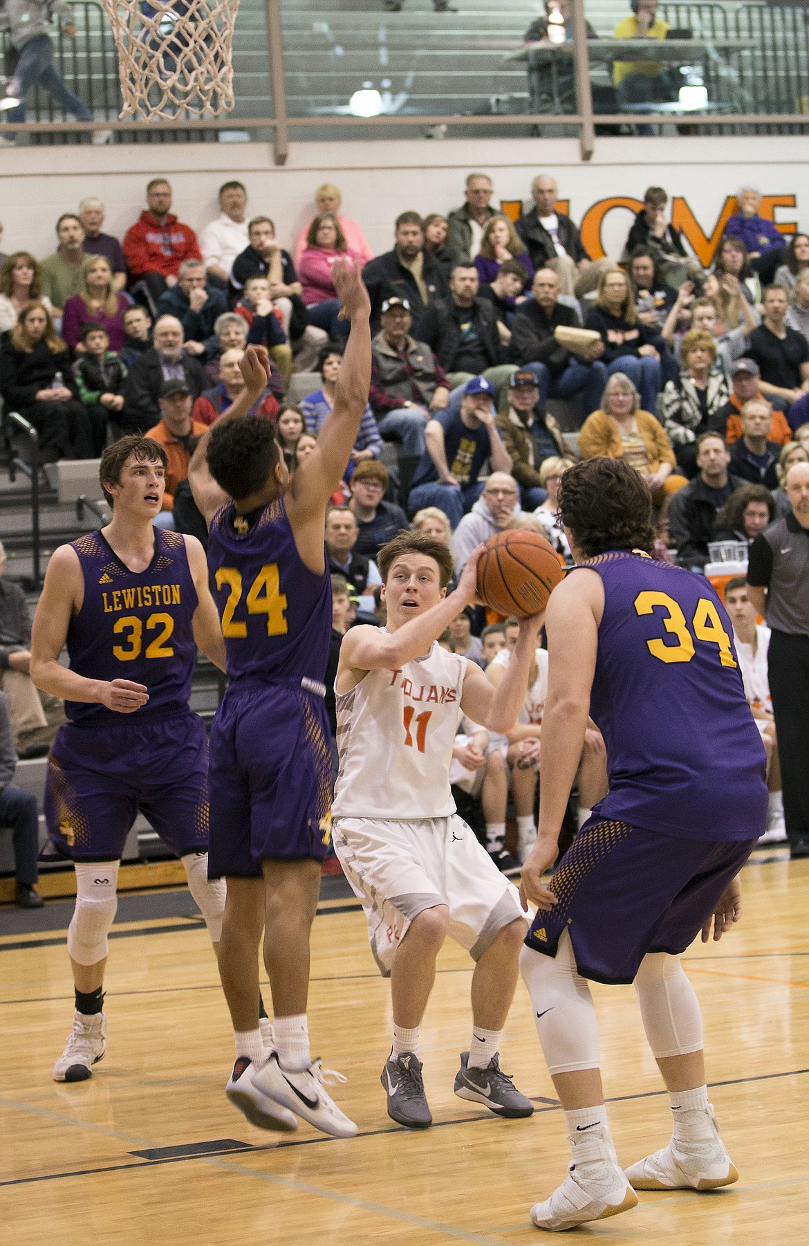 LISA JAMES/ PressCasey Walker, #11, gets ready to shoot as Colton Richardson, #34, Riley Way, #24, and Trystan Bradley, #32, of Lewiston block during their State 5A Region 1 championship game at Post Falls High School on Tuesday night. Post Falls lost to Lewiston, 48-51.