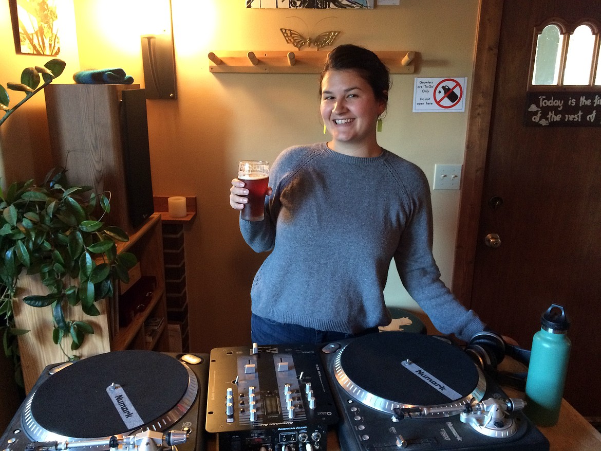 KEELA SMITH, the general manager at Bonsai Brewing, holds a pint in front of the turntables
on a recent Vinyl Night at the Whitefish brewery. (Eric Waier photos/This Week in the Flathead)