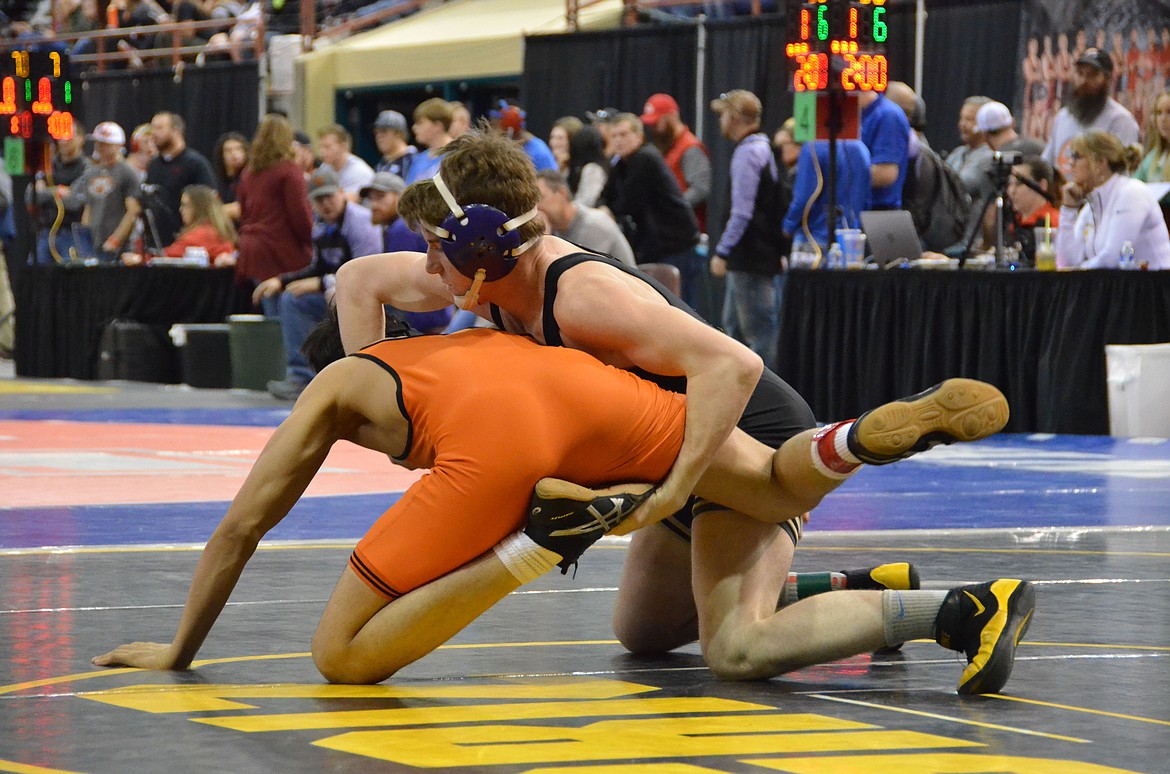 Photos by Amy Stepro
Wildcat senior Tanner Figueroa attempts to flip his opposition during an early round match. Figueroa is still in contention for a state championship.