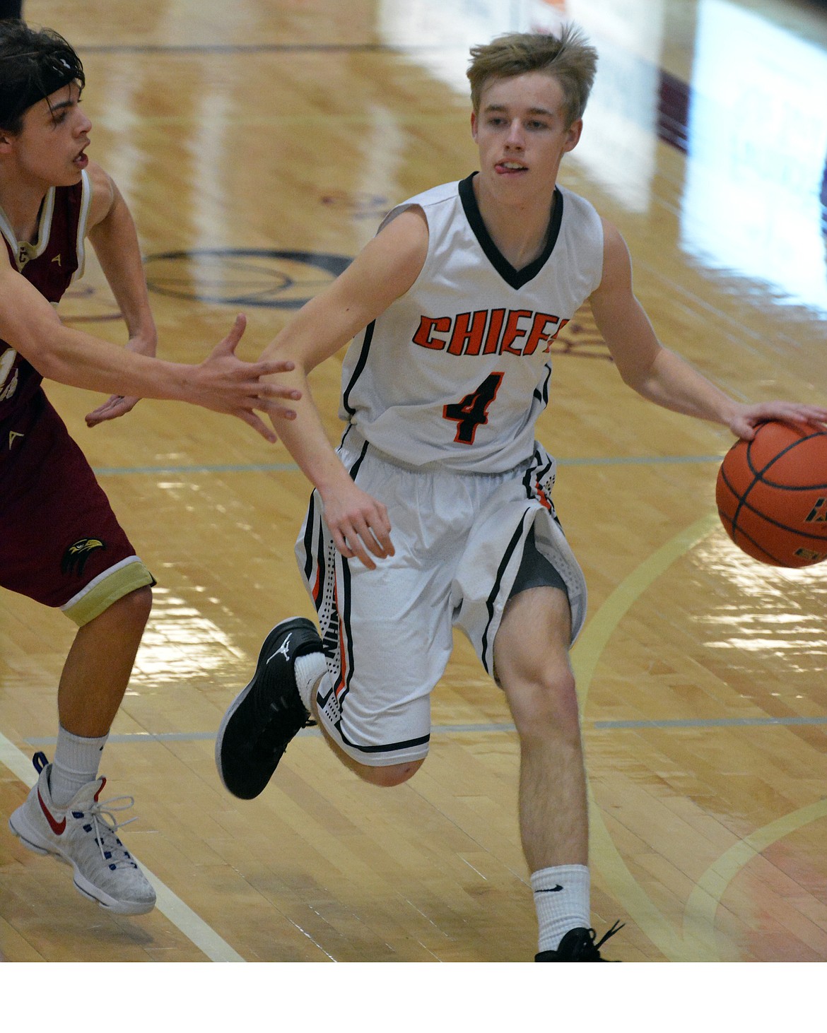 RONAN CHIEFS guard Jackson Duffey attempts to take the ball to the basket in the first round of the Western Class 6B District Thursday at Hamilton High School. (Jason Blasco/Lake County Leader)