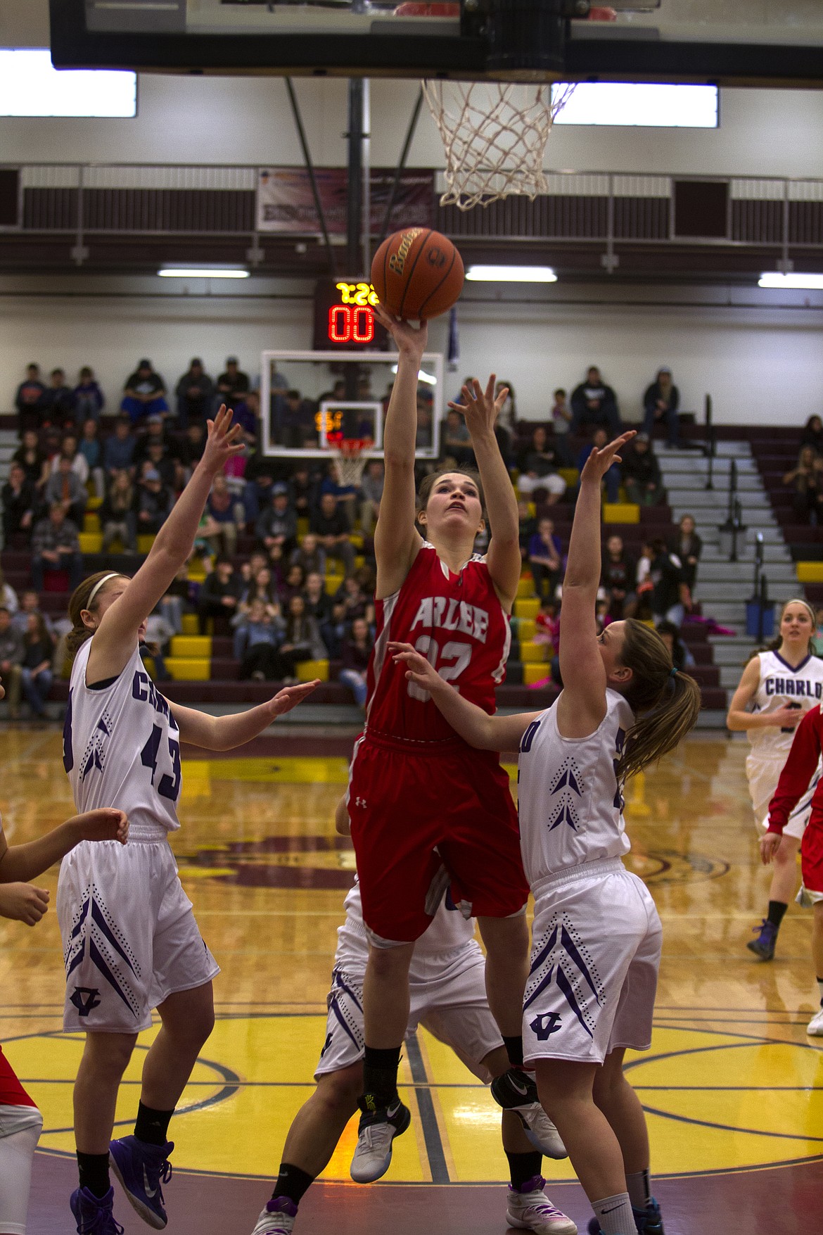 Arlee forward Bryndle Goyins goes up for a shot over several Charlo defenders in the District 14C semifinal Friday in Pablo. (Jeremy Weber/Lake County Leader)