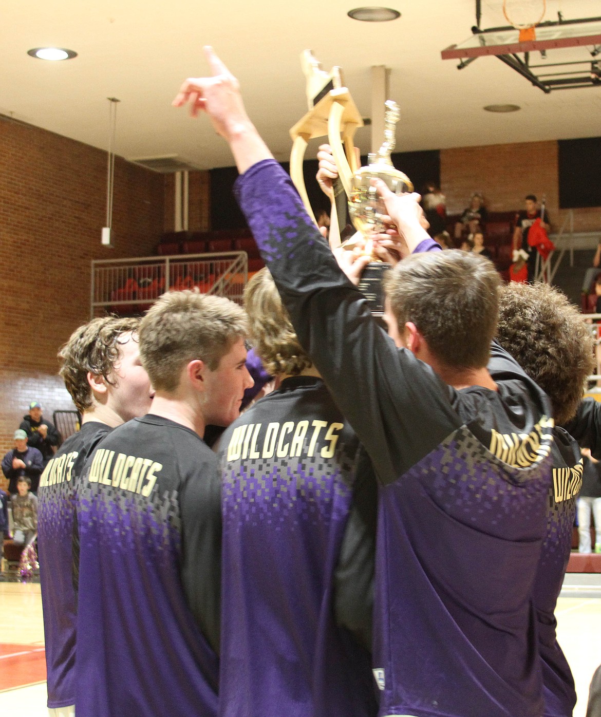 Photos by AriAna McDonald
Tanner Mueller and the rest of the Wildcats share a moment together as champions following their district championship win on Thursday night.