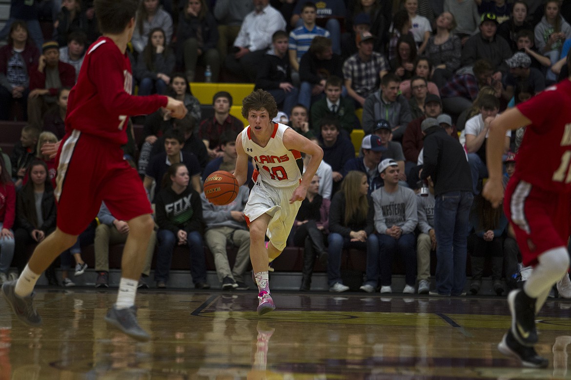 Plains guard Ryan Ovitt brings the ball up the court against Arlee in the District 14C championship game Saturday in Pablo. (Jeremy Weber/Clark Fork Valley Press)