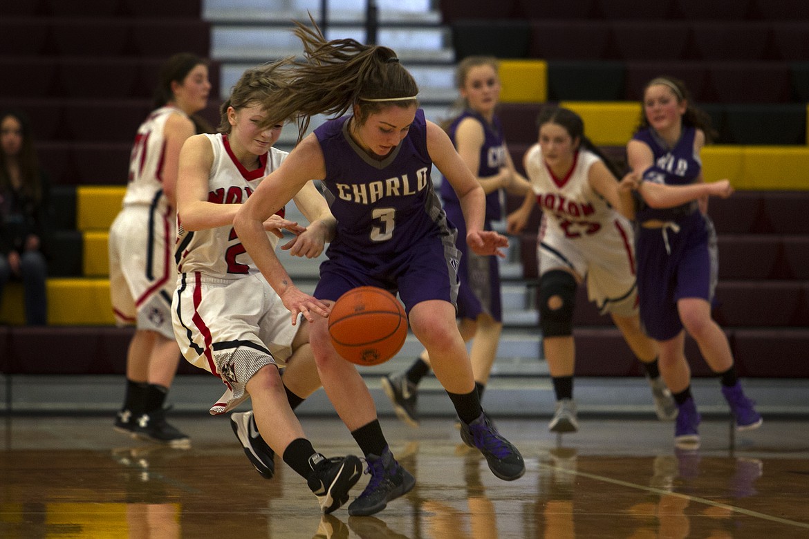 Charlo&#146;s Cheyenne Nagy (3) is hounded by Noxon defender Kamber Torti (2) during tournament action Thursday in Pablo. (Jeremy Weber/Clark Fork Valley Press)