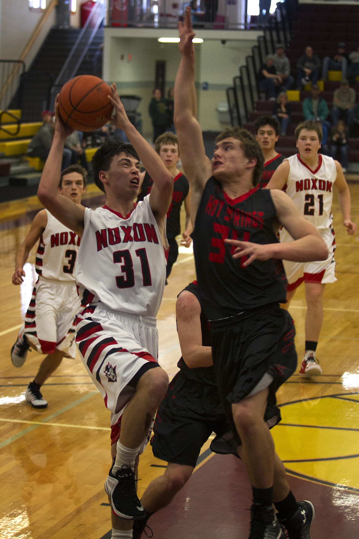 Noxon&#146;s Aaron Brodmerkle (31) goes up for a contested shot against Hot Springs defender Blaine Carr (34) during first-round action at the District 14C Tournament in Pablo Thursday. (Jeremy Weber/Clark Fork Valley Press)