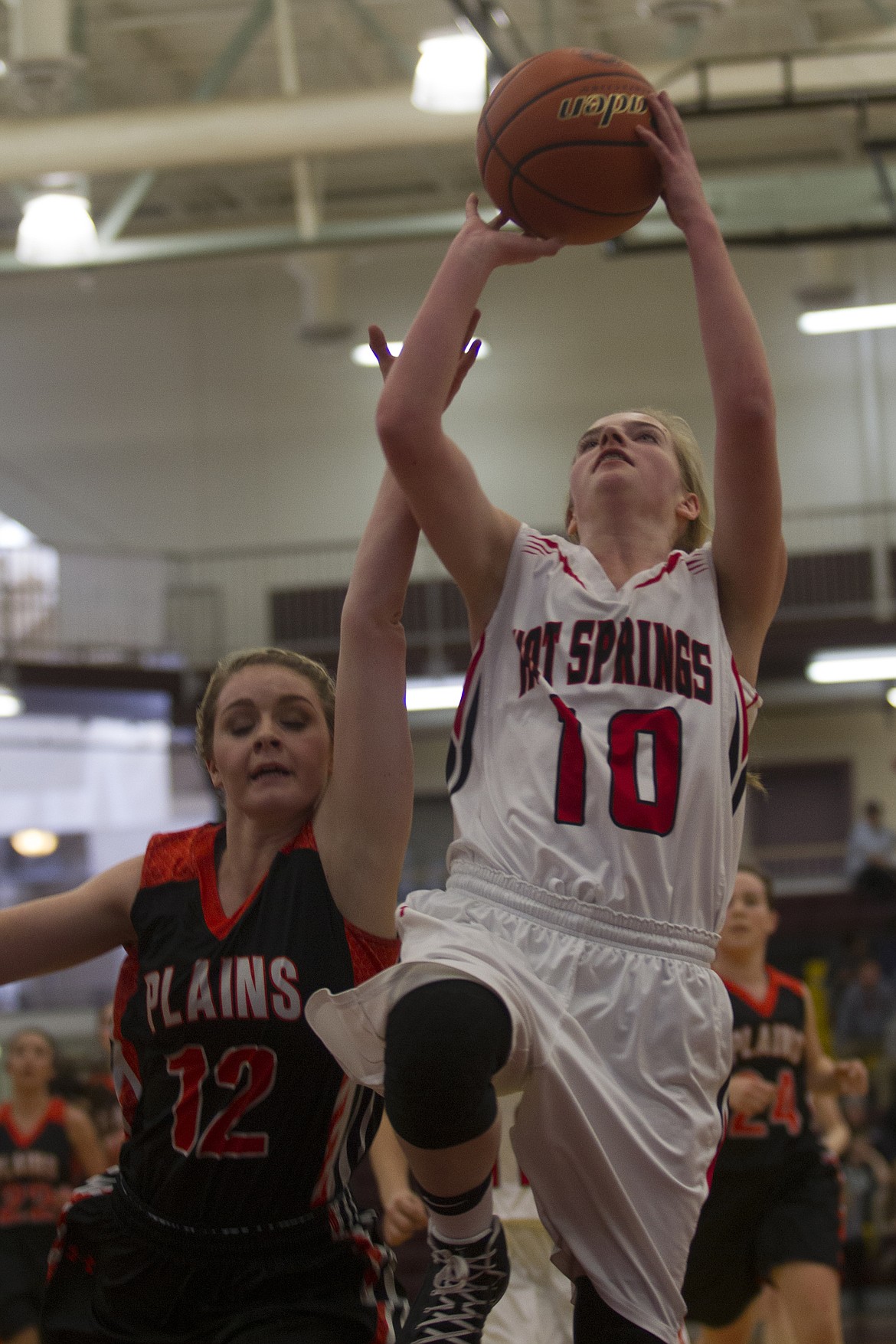 Hot Springs guard Stacy Gray (10) goes up for a layup against Plains defender Lindsay Laws during first-round action at the District 14C Tournament in Pablo Thursday. (Jeremy Weber/Clark Fork Valley Press)