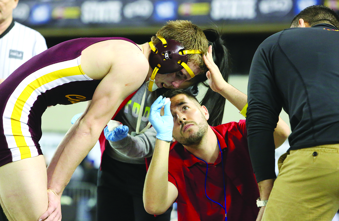 Connor Vanderweyst/Columbia Basin Herald
Officials try to stop Hunter Cruz from bleeding during the state semifinals.