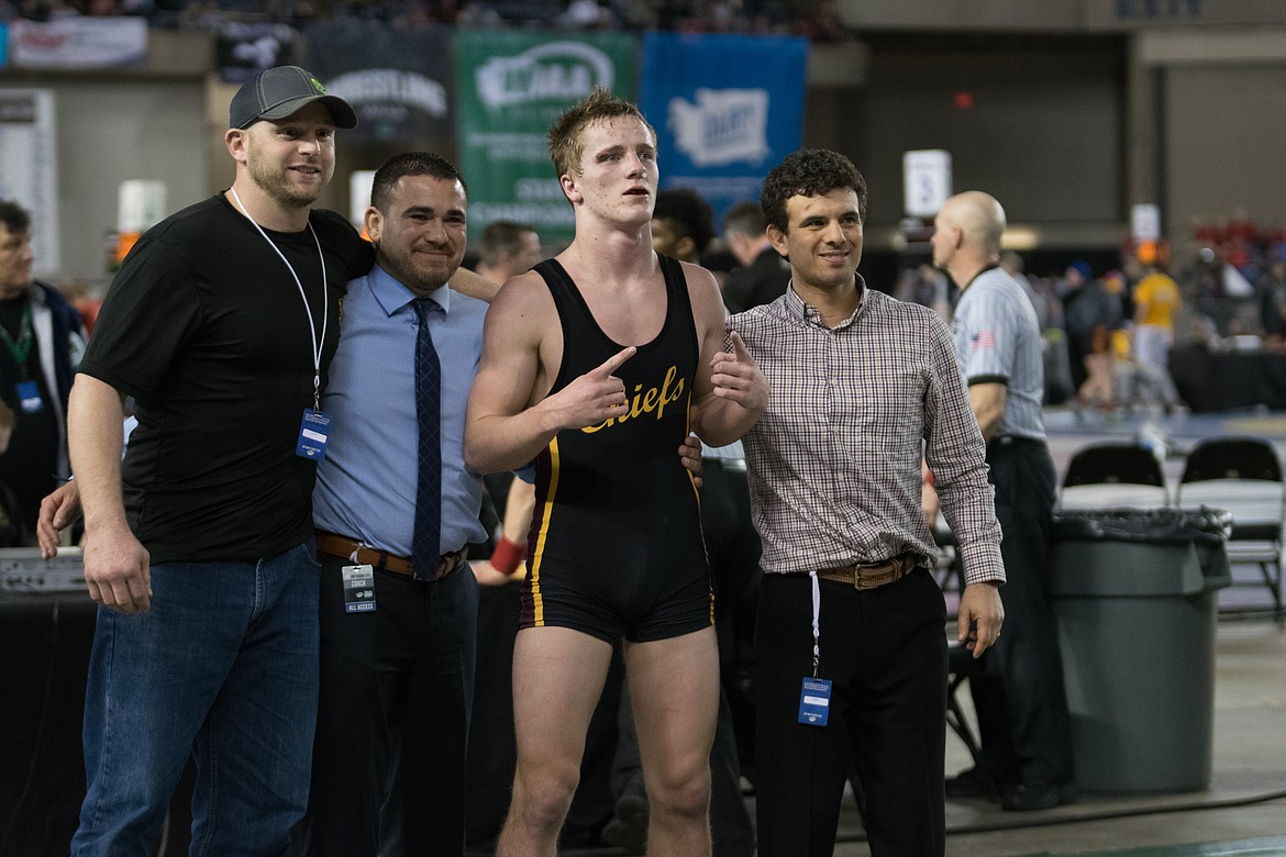 Kennady Schlagel/courtesy photo
Hunter Cruz poses with the Moses Lake coaching staff after winning the 152-pound state championship.