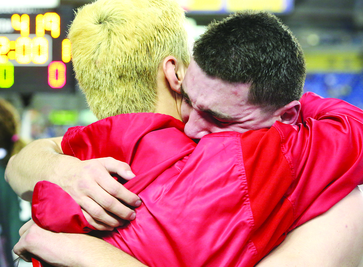 Connor Vanderweyst/Columbia Basin Herald
Othello teammates Reese Jones (left) and T.J. Martinez embrace after Martinez won the 195-pound state championship.