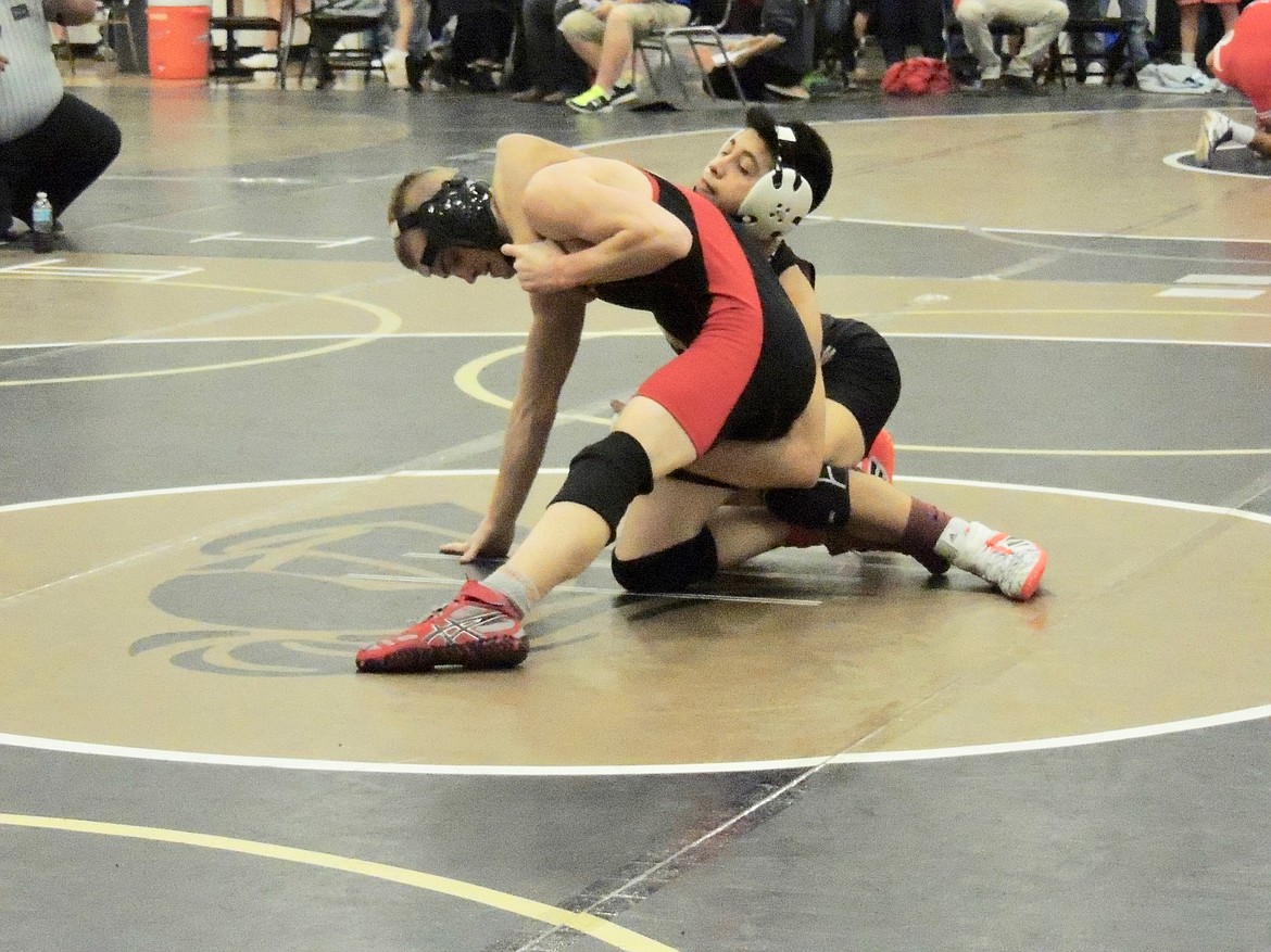 Ted Escobar/The Sun Tribune-  Eduardo Rodriguez of Royal gets a grip on his semifinal opponent on the way to a 12-3 decision.