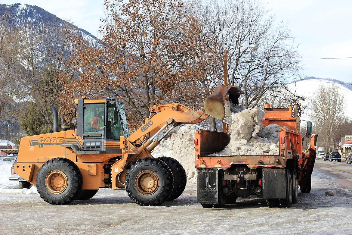 Highway maintenance workers remove large piles of snow from Alberton streets. This helps to alleviate flooding when temperatures warm up. (Kathleen Woodford/Mineral Independent).